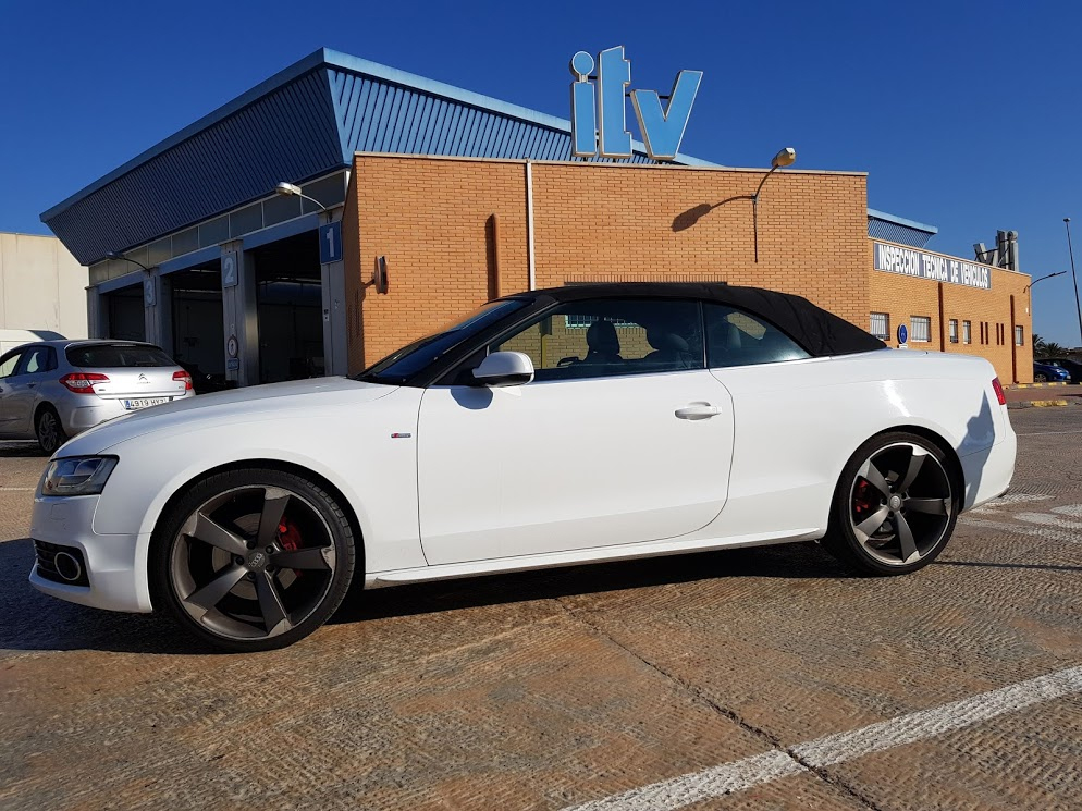 Audi A5 Cabrio waits to be tested for import at ITV station Audi A5 below ITV sign